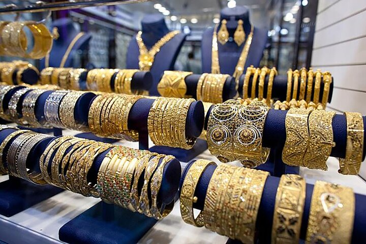 Explore the dazzling selection of intricate gold jewelry at Dubai's Gold Souk where tradition meets luxury amid a bustling market atmosphere perfect for any traveler seeking a unique experience.